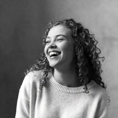 Young woman laughing with curly hair