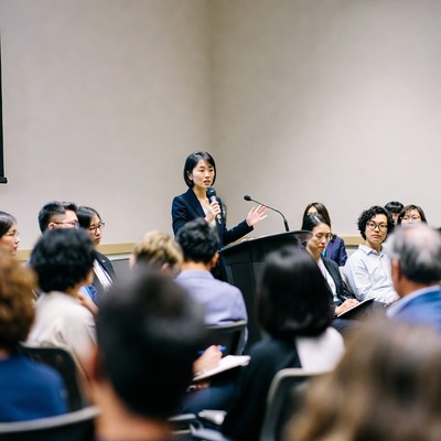 Asian woman speaking at podium