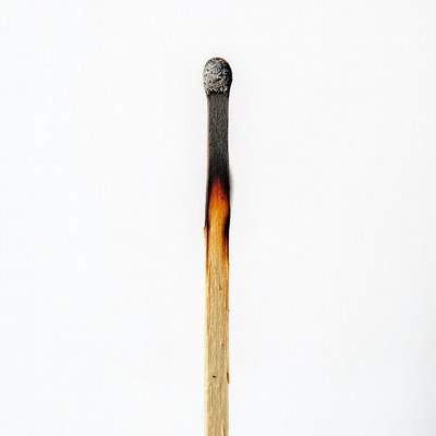 Burned matchstick on white background