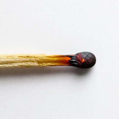 Burned Matchstick on White Background
