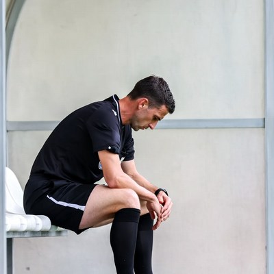 Soccer referee sitting pensively