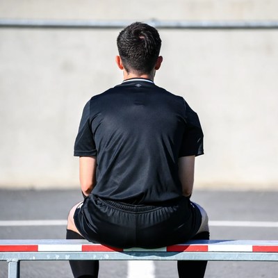 Soccer referee sitting on bench