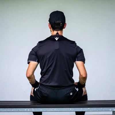 Soccer referee sitting on bench