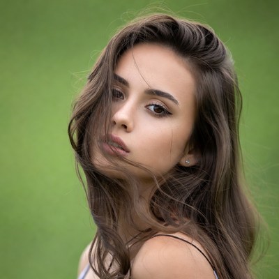 Woman with flowing brown hair in grass