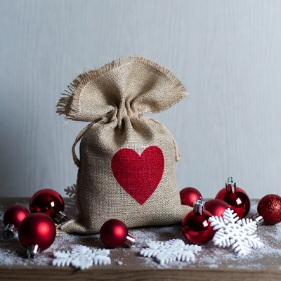Burlap sack with red heart and Christmas ornaments