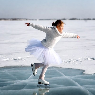 Girl ice skating on frozen lake