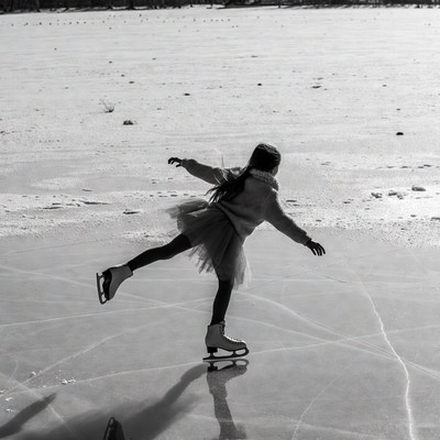 Girl ice skating on frozen lake