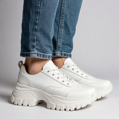 Woman wearing white platform sneakers