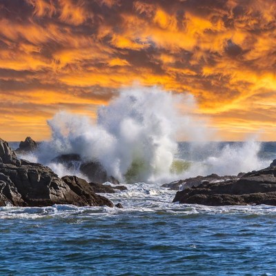Ocean Waves Crashing on Rocks at Sunset