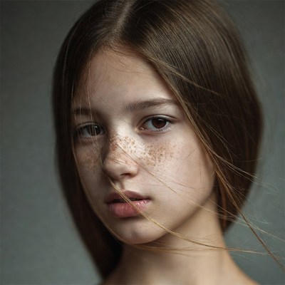 Young girl with freckles close-up