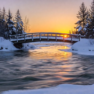 Snowy Wooden Bridge at Sunset