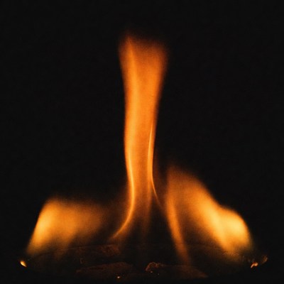 Swirling orange flame isolated on black