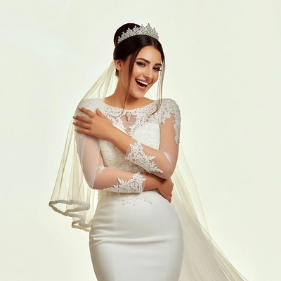Bride in lace wedding gown smiling