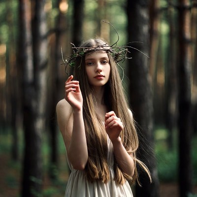 Girl with twig crown in forest