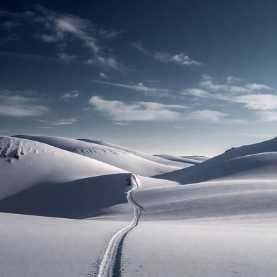 Snowy Mountain Trail Winding Through Hills