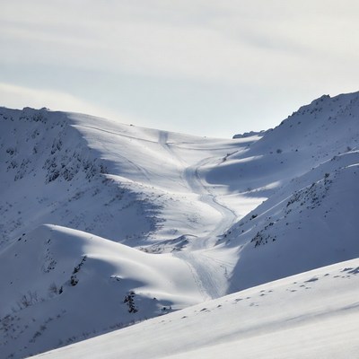 Snowy Ski Slope in Mountains