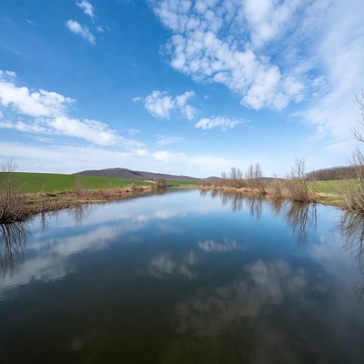 River reflecting hills and clouds
