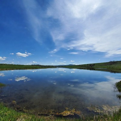 Mountain Lake Reflecting Blue Sky