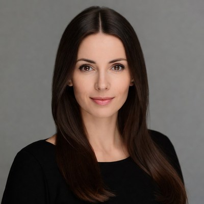 Woman with long dark hair smiling