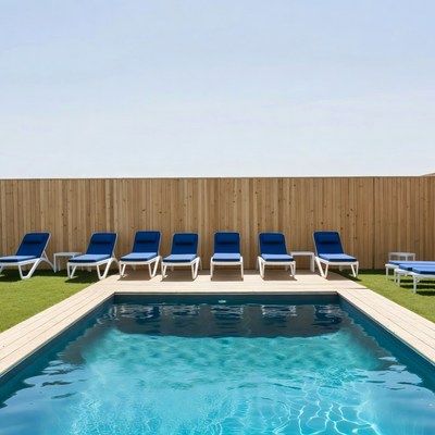 Blue lounge chairs by swimming pool
