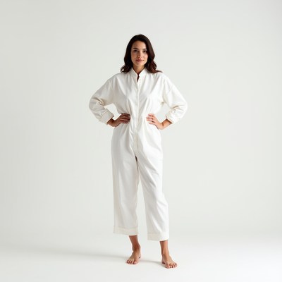 Woman in white jumpsuit hands on hips