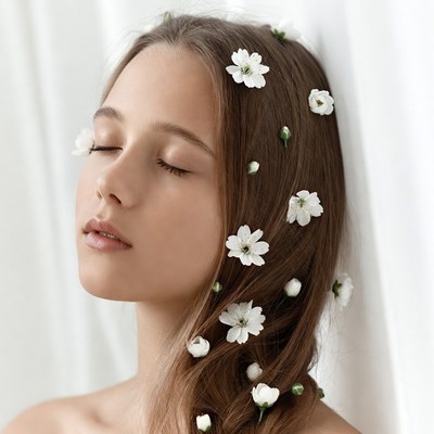 Woman with daisies in brown hair