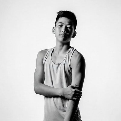 Asian boy in tank top posing