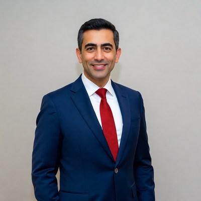 Man in navy suit with red tie