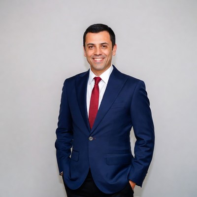 Man in navy suit with red tie