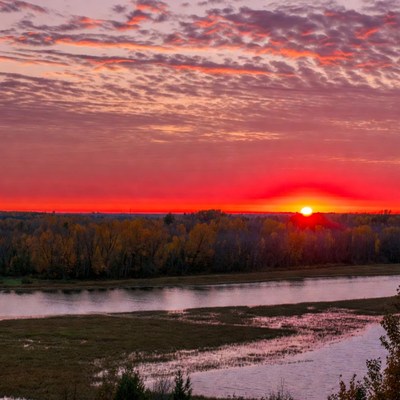 Sunset over river and autumn trees