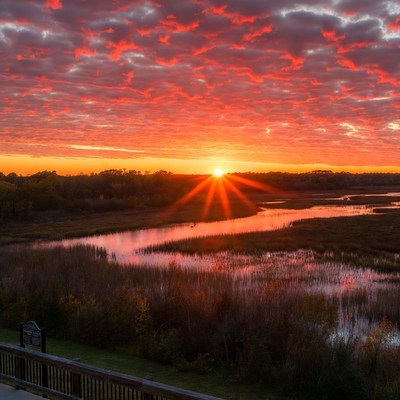 Sunrise over winding river marsh