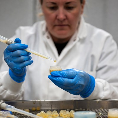 Woman scientist pipetting sample in lab