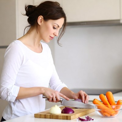 Woman chopping vegetables in kitchen