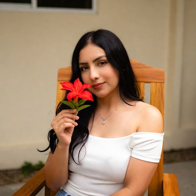 Latina woman holding red flower