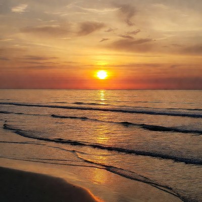 Sunset over ocean waves