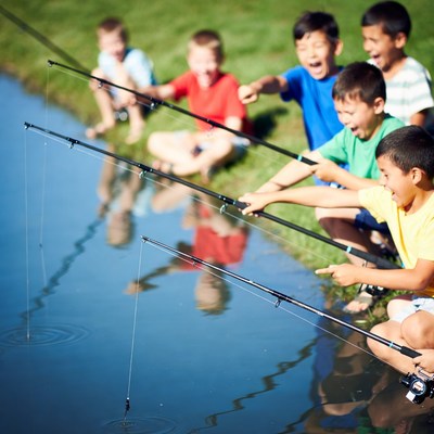 Group of boys fishing by pond