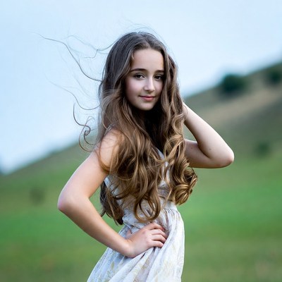 Girl with flowing hair in field