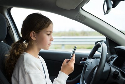 Girl using phone in car