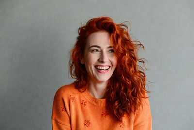 Smiling woman with red curly hair