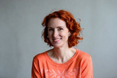 Smiling woman with red curly hair