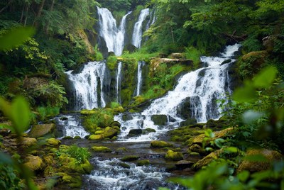 Majestic multi-tiered waterfall in lush forest