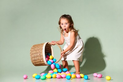 Girl spilling colorful Easter eggs
