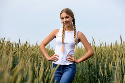 Girl with braids in wheat field