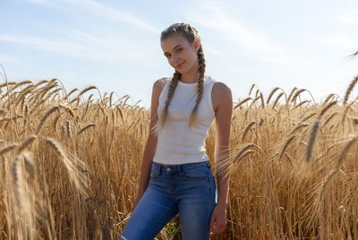 Girl in white tank top wheat field