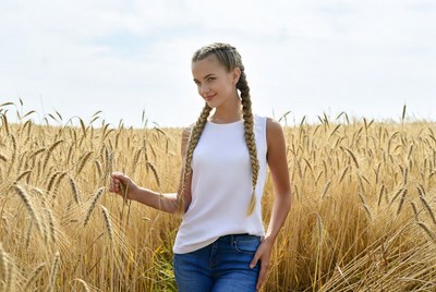 Woman with braids in wheat field