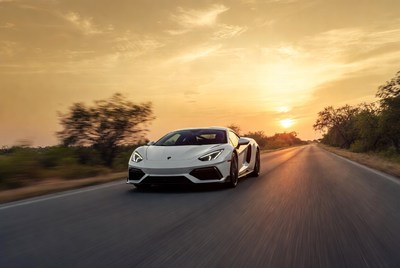 White Lamborghini Driving at Sunset