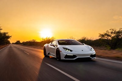 White Lamborghini Huracan Driving at Sunset
