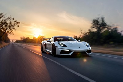White Porsche 718 Cayman GT4 Driving at Sunset