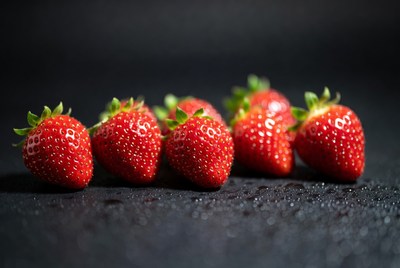 Fresh strawberries on black background