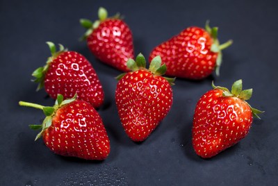 Fresh ripe strawberries on black background